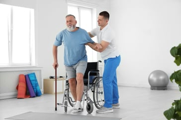 Physiotherapist doing exercises with senior in rehab facility