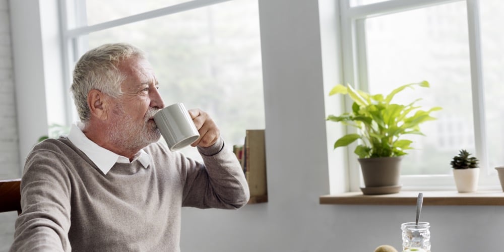 Senior drinking from mug