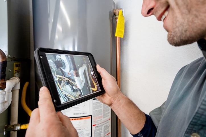 Maintenance technician researching Property Management Maintenance Software to save time when prioritizing maintenance work