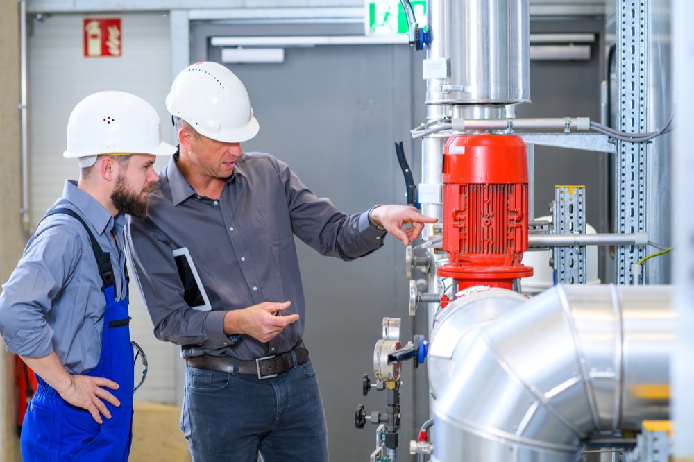 two men keeping track of maintenance with service order software